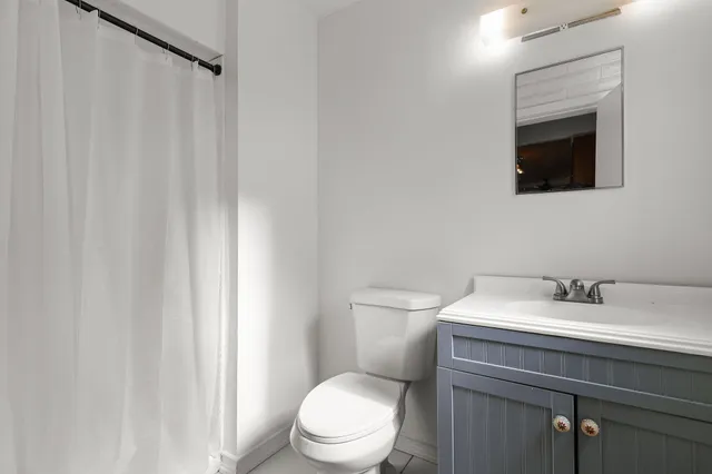 a white toilet sitting next to a bathroom sink