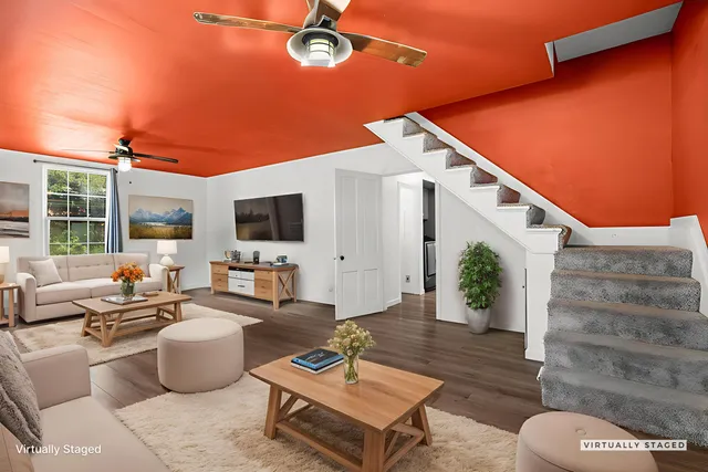 a living room with patio furniture and a flat screen tv