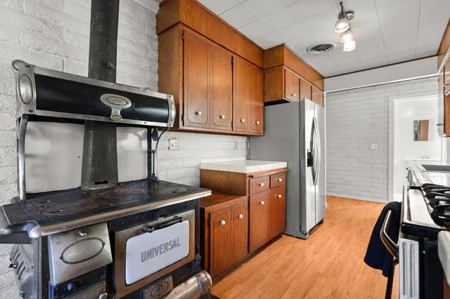 a kitchen with stainless steel appliances granite countertop a stove and a refrigerator