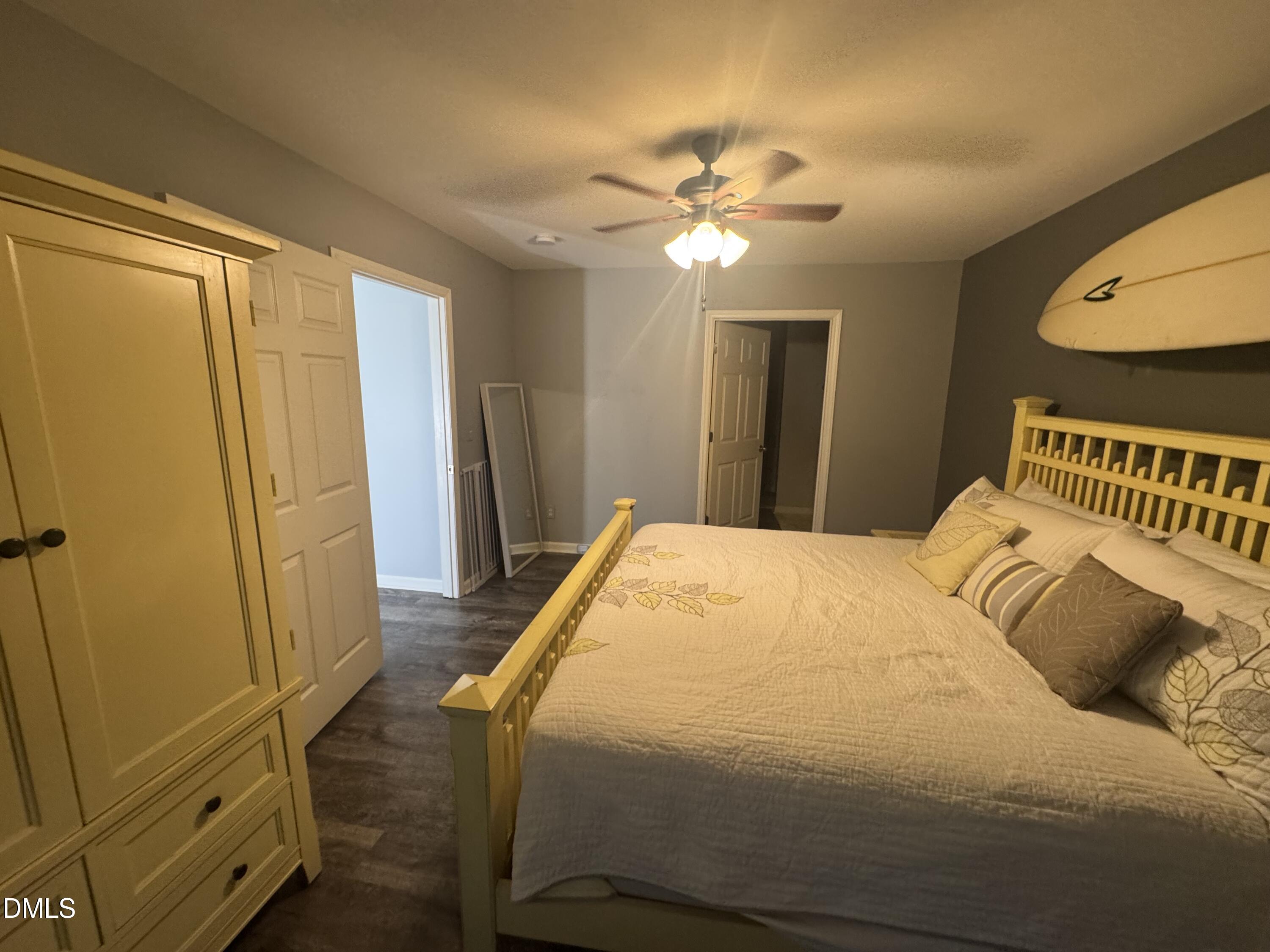 11351 Clubhaven Place, Unit 100 Raleigh, NC 27617 - Photo 17 of 29 a bedroom with a bed and a chandelier