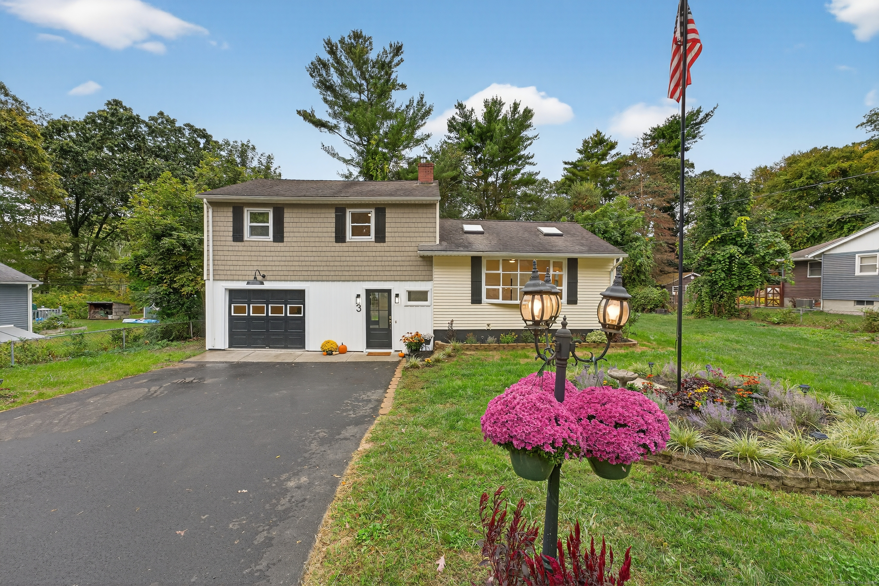 a front view of a house with a yard and fountain
