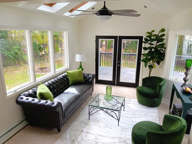 a living room with furniture and a large window