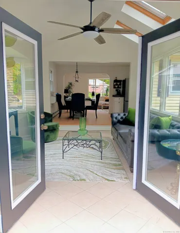 a view of a livingroom with furniture and a ceiling fan