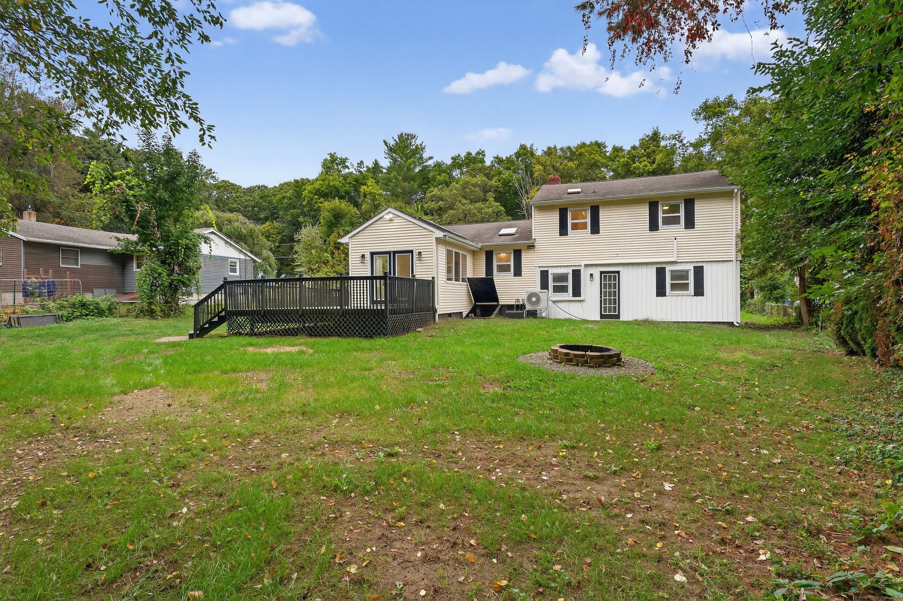 3 Webster Drive 1 Preston, CT 06365 - Photo 20 of 37 a front view of a house with a yard table and chairs