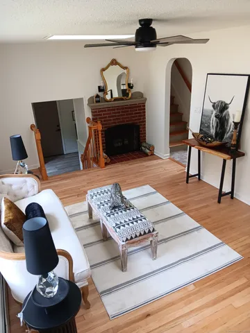 a living room with furniture and wooden floor