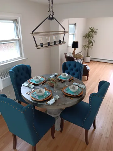 a view of a dining room with furniture and window