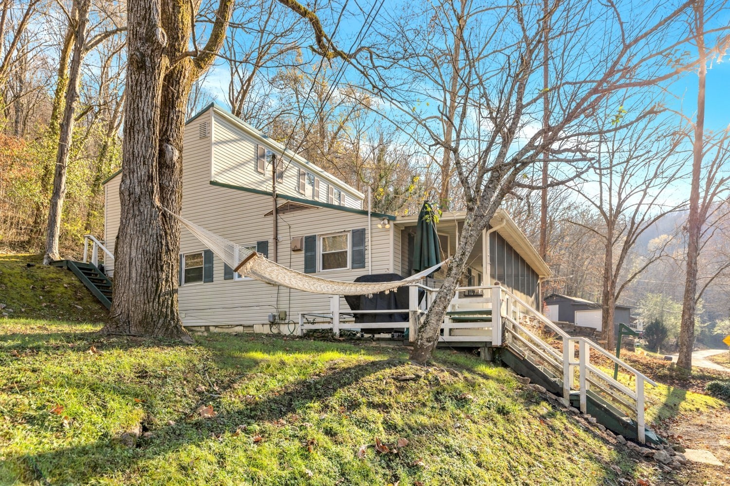 3745 Holmes Creek Road Smithville, TN 37166 - Photo 3 of 23 a view of a house with a large tree and a yard