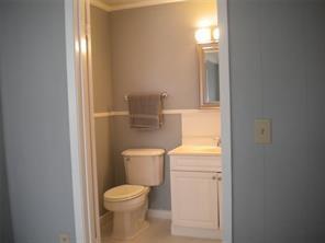 617 Laura Street Mansfield, LA 71052 - Photo 5 of 9 a white toilet sitting next to a bathroom sink