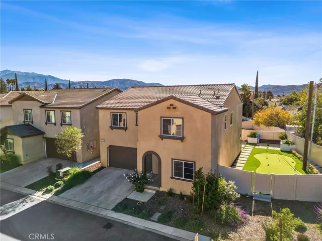 an aerial view of a house with a yard basket ball court and outdoor seating