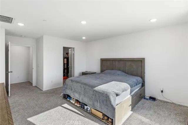 a bedroom with a bed and a night stand