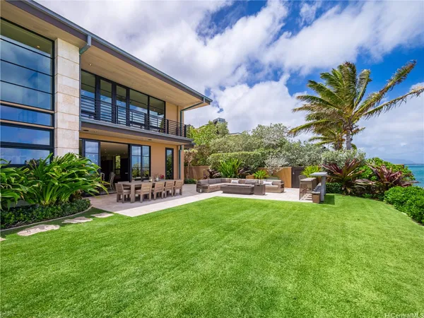 a view of a house with swimming pool and sitting area