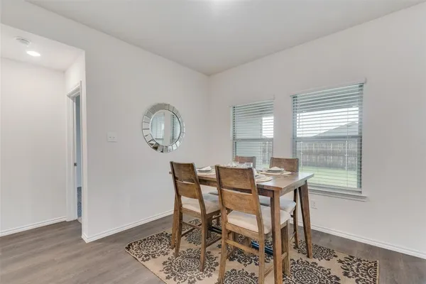 a view of a dining room with furniture and window