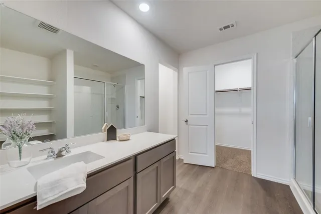 a bathroom with a double vanity sink and mirror
