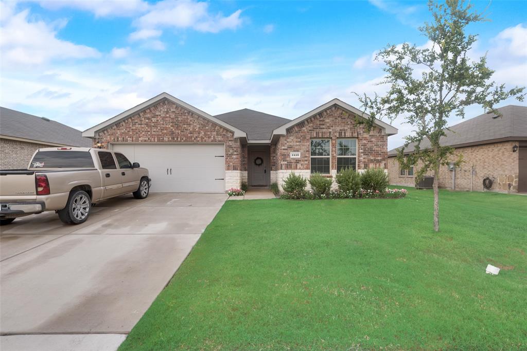 1413 Thunder Cyn Way Royse City, TX 75189 - Photo 2 of 24 a front view of a house with a garden and yard