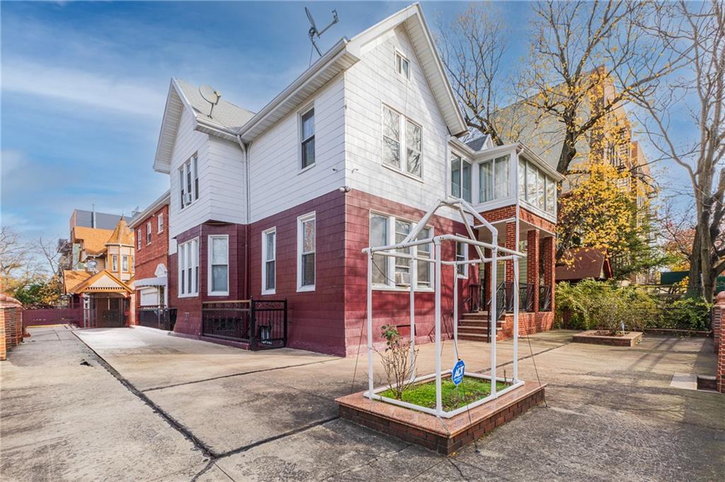 1027 Bushwick Avenue Brooklyn, NY 11221 - Photo 1 of 10 a wooden bench sitting in front of a building