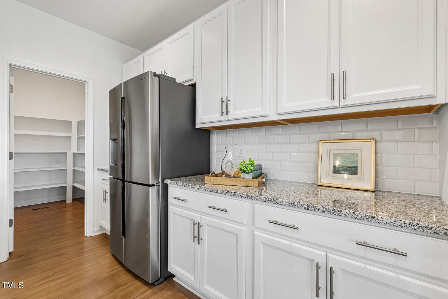 143 Rossell Park Circle Garner, NC 27529 - Photo 10 of 42 a kitchen with granite countertop stainless steel appliances a refrigerator and cabinets