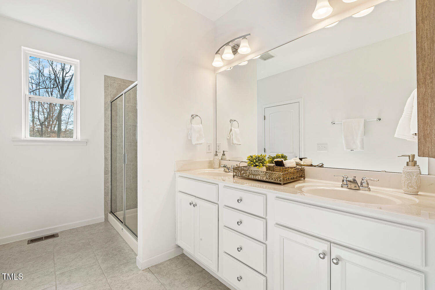 143 Rossell Park Circle Garner, NC 27529 - Photo 23 of 42 a bathroom with a double vanity sink and mirror