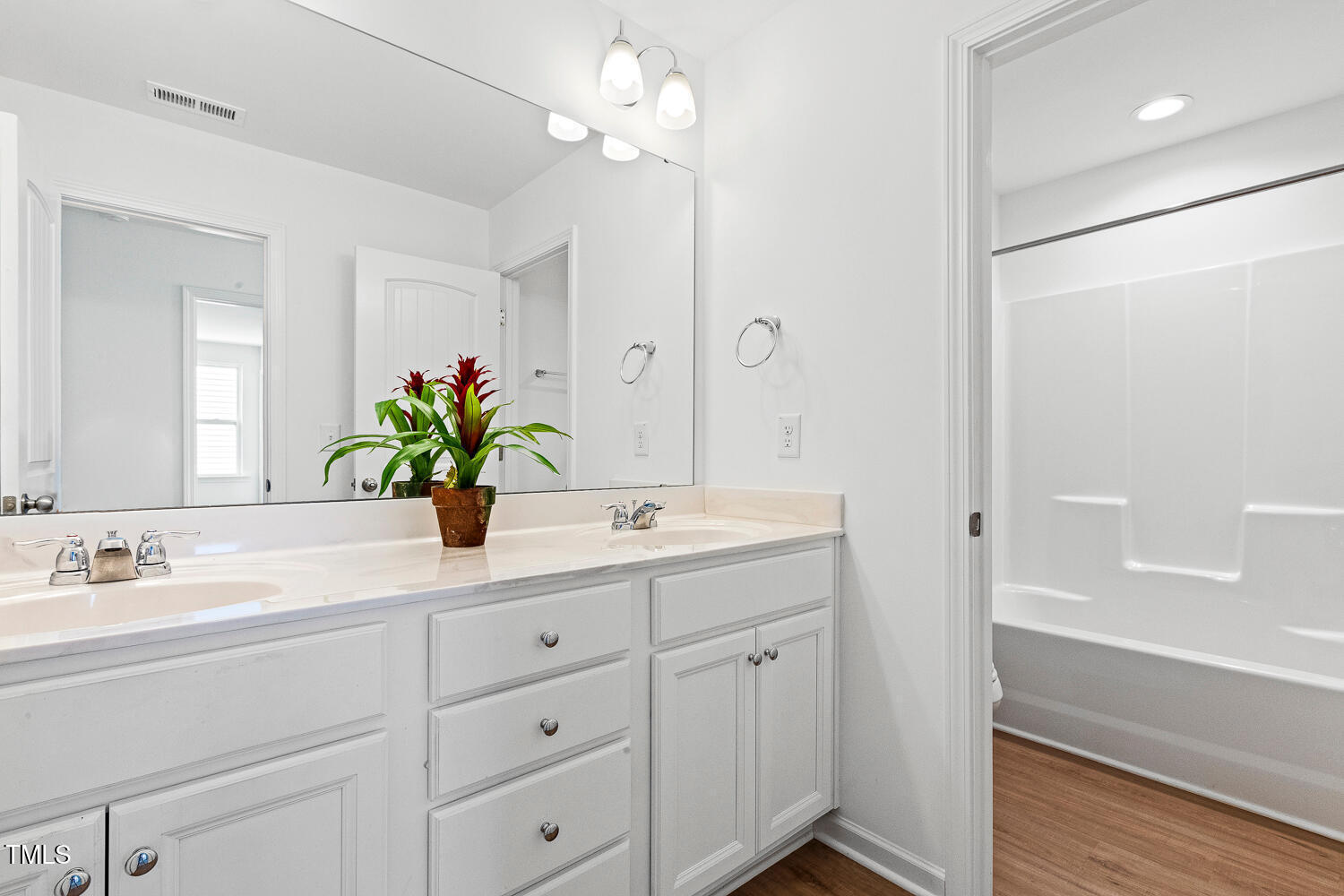 143 Rossell Park Circle Garner, NC 27529 - Photo 29 of 42 a bathroom with a shower sink and mirror