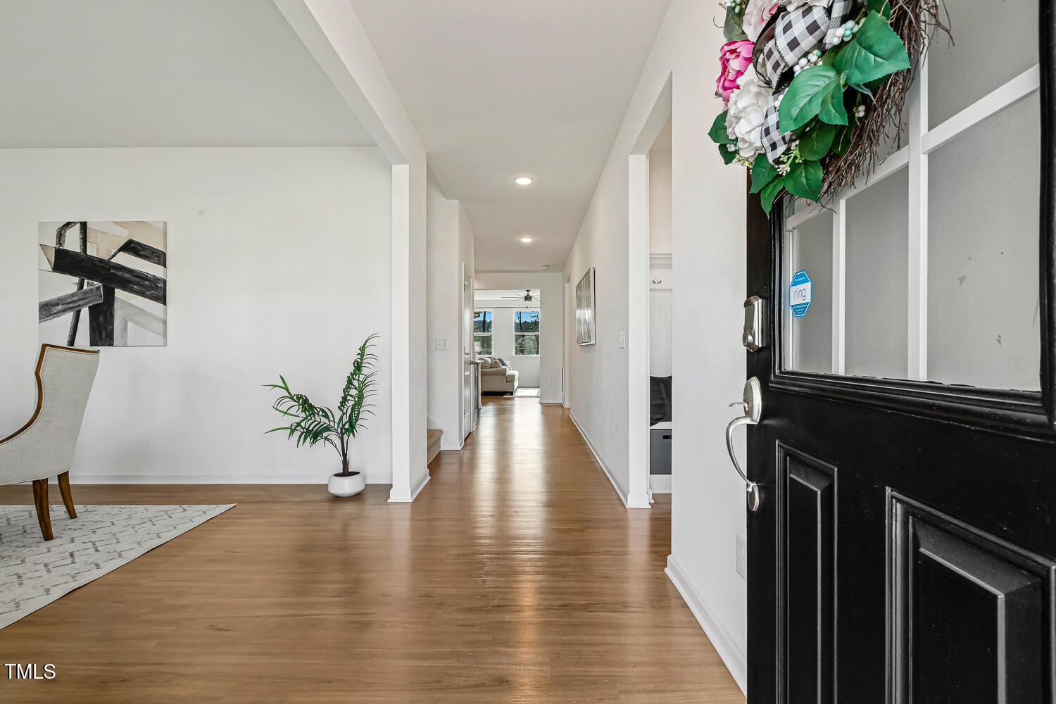 143 Rossell Park Circle Garner, NC 27529 - Photo 3 of 42 a view of a hallway with wooden floor and a potted plant
