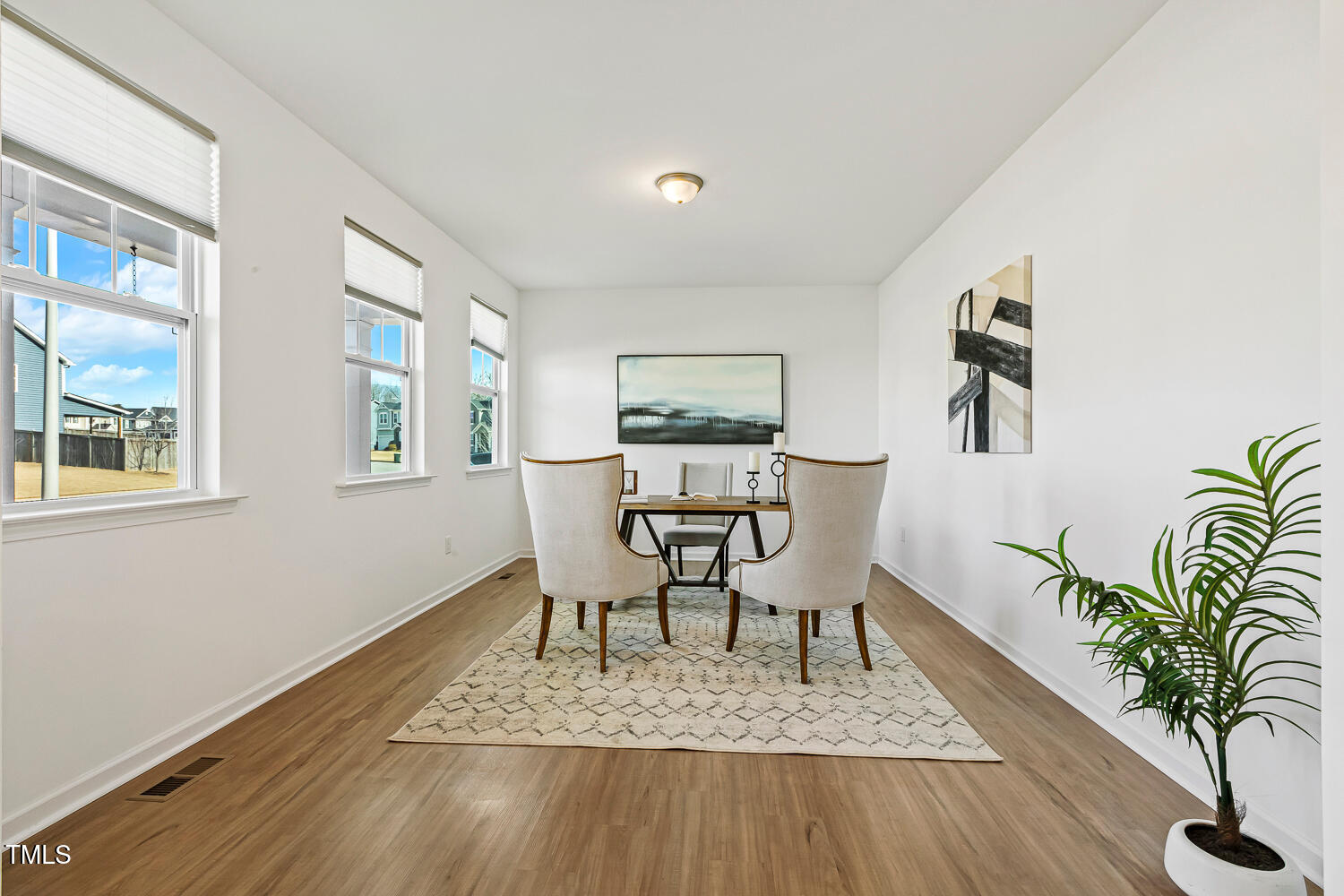 143 Rossell Park Circle Garner, NC 27529 - Photo 4 of 42 a view of a dining room with furniture and wooden floor