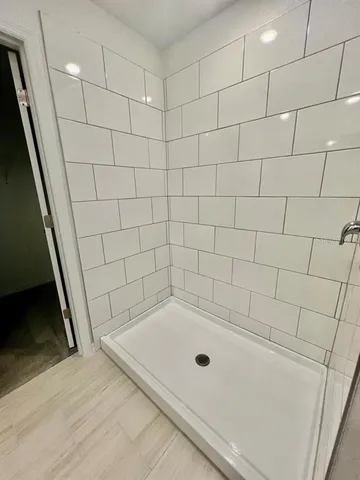 a bathroom with a tub and a shower