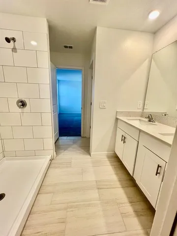 a bathroom with a sink a toilet and shower
