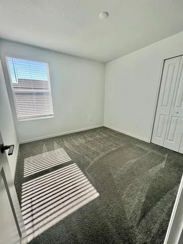 a view of a room with wooden floor and cabinet