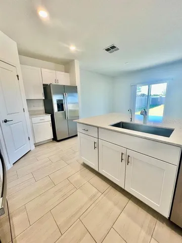 a kitchen with a sink and cabinets