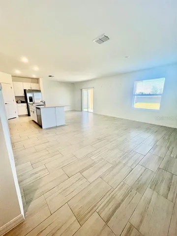a view of a kitchen with a sink and a window