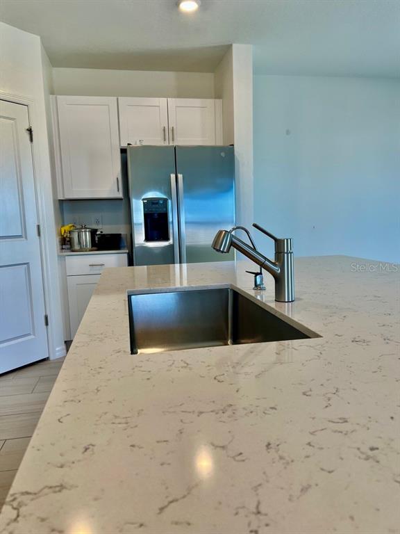 9023 Bay Leaf Drive Parrish, FL 34219 - Photo 10 of 31 a kitchen with kitchen island a sink stainless steel appliances and cabinets