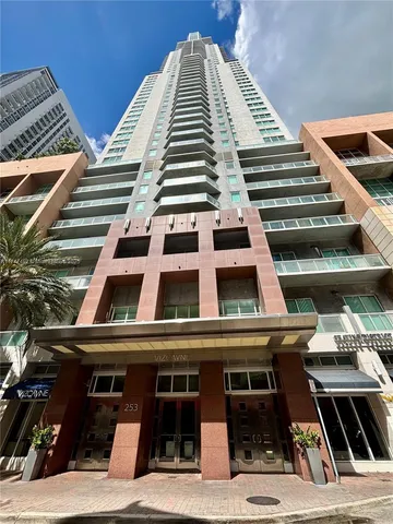 a view of a building with a yard and plants