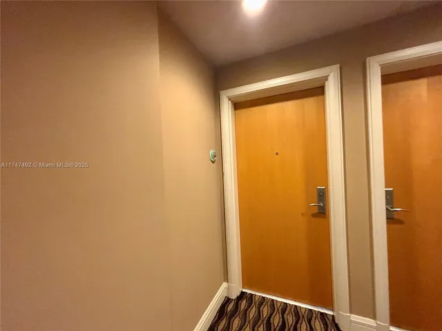 a close view of a refrigerator in kitchen and wooden floor