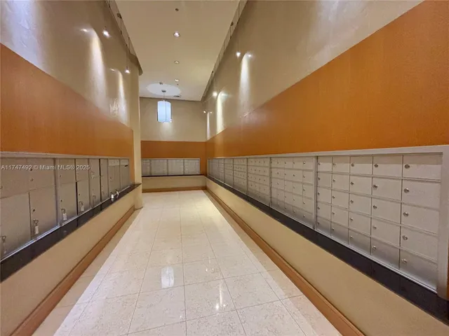 a kitchen with stainless steel appliances granite countertop a refrigerator a stove and a sink with wooden floor