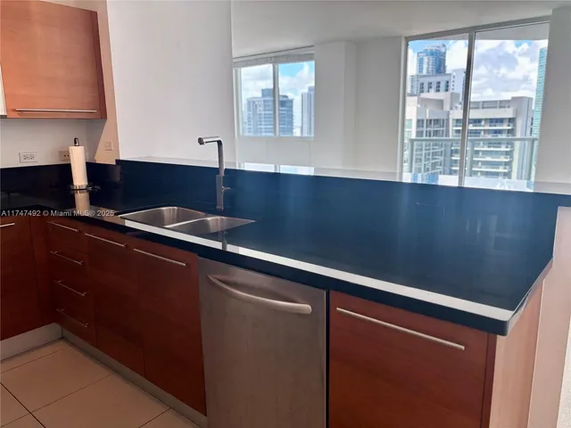 a kitchen with granite countertop a stove and a sink