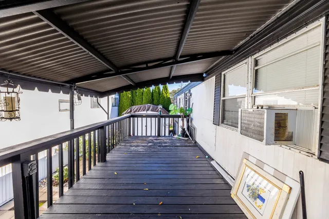a view of a house with a tree next to a road