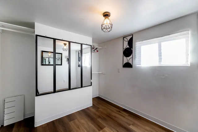 a view of a room with wooden floor and windows
