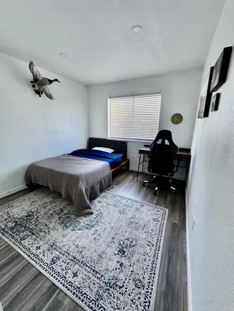 a bedroom with furniture and a window