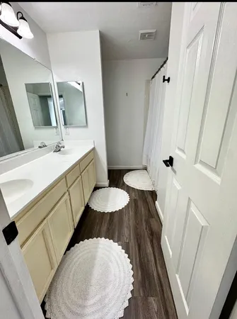 a bathroom with a sink a toilet and mirror
