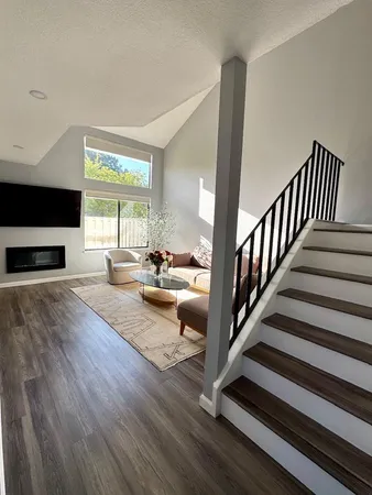a view of living room with furniture and a flat screen tv