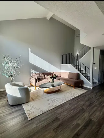 a bedroom with furniture and a wooden floor