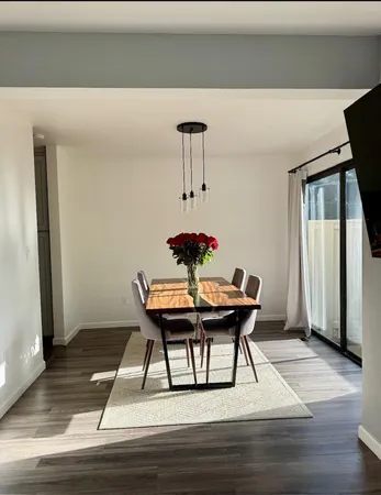 a view of a dining room with a table and chairs