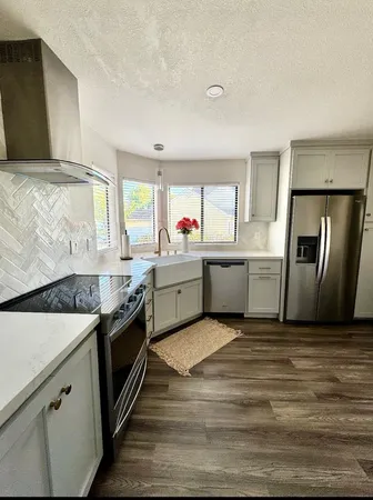 a kitchen with stainless steel appliances granite countertop a sink and stove top oven