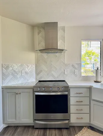 a stove top oven sitting inside of a kitchen