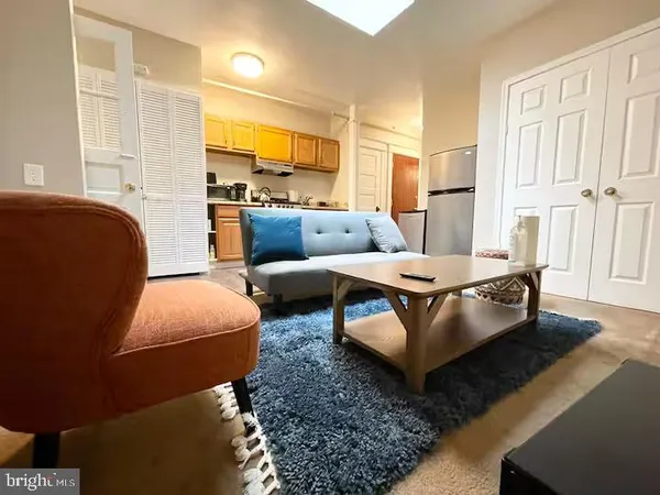 a living room with furniture and a rug