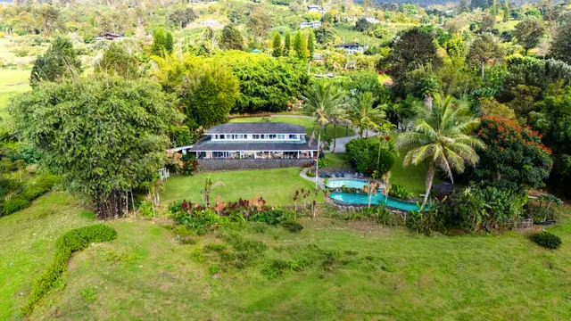 an aerial view of a house with a yard