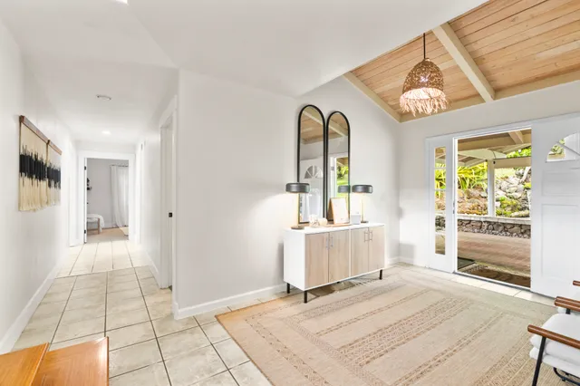 a view of a hallway with wooden floor and furniture