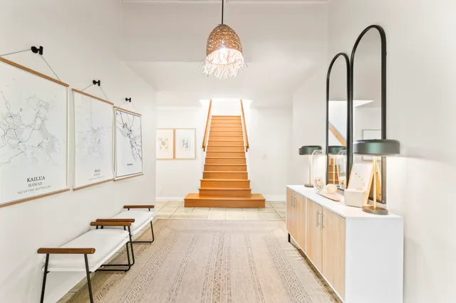 a view of a room with wooden floor and windows