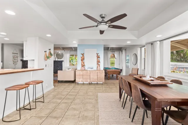 a living room with furniture a dining table and a window