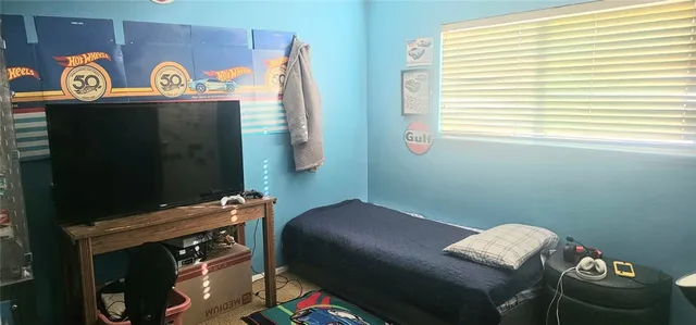 a bedroom with a bed and a window