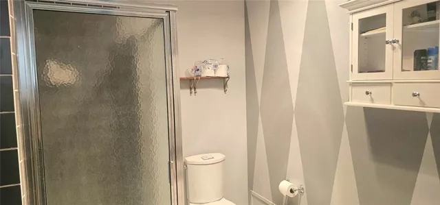 a bathroom with a shower and a sink